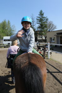 Uczeń podczas ćwiczenia jazdy tyłem na koniu.